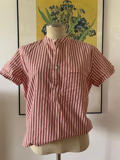 This cute deadstock shirt is a great one to pair with so much. It's a minimalist casual shirt with red and white stripes all over. It has a pocket in the bust and buttons half up. Size Medium (M). No returns. FOLLOW US + Instagram @thriftgathershop Collared T-shirt For Beach With Relaxed Fit, Summer Cotton Shirt For Daywear, Collared Cotton Beach T-shirt, Collared Cotton T-shirt For The Beach, Cotton Relaxed Fit Camp Shirt For Daywear, Relaxed Fit Cotton Camp Shirt For Daywear, Relaxed Cotton Camp Shirt For Daywear, Red Camp Collar Top For Summer, Red Shirt For Summer Daywear