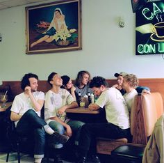 a group of men sitting at a table in a restaurant