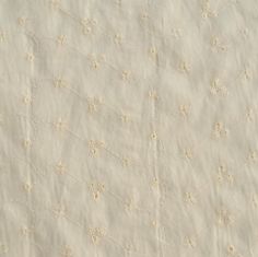 an old white cloth with small flowers and lines on the fabric, as if it were made from linen