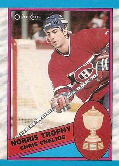 the hockey card has an image of a man in red jersey holding a gold trophy