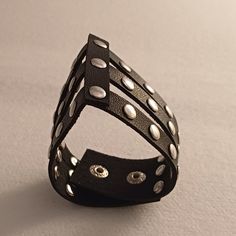 Approximately 7" Black Rock Jewelry, Punk Black Bracelet With Silver Studs, Silver Punk Leather Bracelet, Black Gothic Leather Bracelet For Festivals, Black Leather Bracelet With Rivets For Concerts, Black Rocker Bracelets With Rivets, Black Leather Bracelet With Rivets In Alternative Style, Black Rivet Rocker Bracelets, Black Rocker Bracelets For Festivals