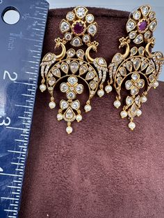 Peacock CZ Matte Chandballi pushback earringsColor : Matte GoldenSize : Length : 2.75 Inches; Weight : 13 grams eachStones : AD Stones Pearls Beads Traditional Earrings, Social Events, Indian Jewelry, Pearl Beads, Beads, Stone