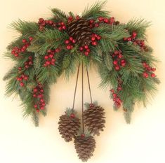 pine cones and berries are hanging on the wall