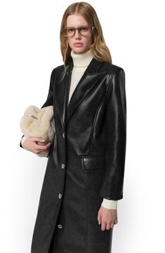 This long, slim coat made from sleek faux leather is tailored with peaked lapels and flap pockets, while the structured shoulders are lightly padded for a gently commanding presence. Front button closure Peaked lapels Front flap pockets 100% recycled-polyester lining 100% recycled polyester with polyurethane coating Dry clean Imported Fall Outerwear, Kids Outerwear, Straight Dress, Travel Pouch, Quality Fashion, Leather Coat, Faux Suede, Clothing Store, Jacket Tops