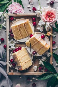 two slices of cake on plates with flowers and greenery around them, one slice has been cut