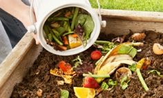 a wooden box filled with dirt and vegetables