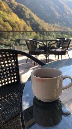 a coffee cup sitting on top of a glass table