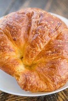 a croissant sitting on top of a white plate