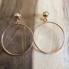 Dangling clip on earrings. Gold or silver coloured alloy hoops dangling from hinged screwback or clip on closures. Lightweight and screwbacks are adjustable. Clip on closures have slightly larger domes than the screwback variation (see photos), and the metal colour of the golden clips may vary.  Earrings are not intended to be worn while sleeping bathing or swimming. Earrings are not intended to be worn while sleeping bathing or swimming. See more: https://www.etsy.com/ca/shop/CleverLittleEars C Metal Hoop Clip-on Earrings For Gift, Metal Small Hoop Clip-on Earrings, Adjustable Hoop Clip-on Jewelry, Metal Clip-on Round Jewelry, Adjustable Gold Clip-on Jewelry, Gold Clip-on Earrings, Small Metal Clip-on Hoop Earrings, Gold Small Hoop Clip-on Earrings, Gold Round Clip-on Earrings