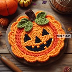 a crocheted pumpkin is sitting on a plate