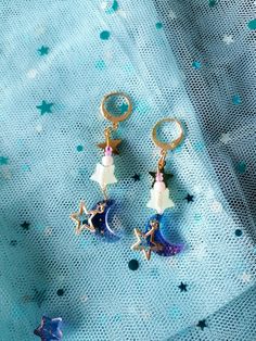 🌌 Starry Night Earrings - Handcrafted Jewelry with Star and Moon Pendants Add a dash of celestial magic to your style with these witchy earrings!  🌟 The earrings are finished with high-quality, 100% stainless steel ear loops, coated with 18K gold. These hooks are nickel-free, lead-free, and rust-free, measuring 18 mm, making them both safe for sensitive ears and stylish.  🦋Please note: These earrings are delicate handmade items, so handle with care to maintain their charm and longevity.🦋 Celestial Star-shaped Hypoallergenic Earrings, Celestial Star Hypoallergenic Earrings, Witchy Earrings, Celestial Magic, Star And Moon, Artist Alley, Moon Pendant, Ear Loop, Stars And Moon