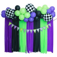 some balloons and streamers are in the shape of checkerboard on purple, green and black