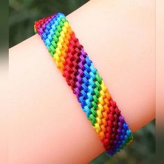 a close up of a person wearing a colorful bracelet