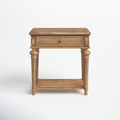 a small wooden table with one drawer on the top and two drawers on the bottom