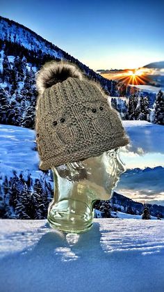 a hat on top of a head in the snow