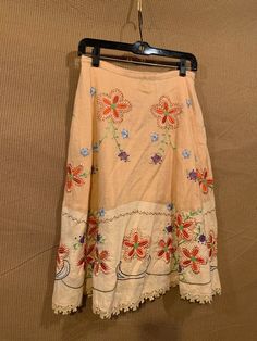 "Fun, beautifully detailed A-line swing skirt.  Peach in color with multiple colors of stitching and beading.  100% linen, fully lined.  Perfect for the warm weather dressed or dressed down. Excellent condition - may need a freshening of an iron. tag reads:  Autograph 100% linen (shell) - 100% cotton (lining) size 2 condition: Excellent condition! No stains or tears.  features:  side hidden zipper  front and back pockets measurements:  waist: 28\" inseam: 26\" Thank you so much for looking & please feel free to message us with any questions!" Bohemian A-line Lined Skirt, Spring Embroidered Beige Skirt, Traditional Full Skirt For Spring, Spring Embroidered Full Skirt, Summer Long Embroidered Skirt, Spring A-line Skirt With Floral Embroidery, Summer Embroidered Long Skirt, Embroidered Full Skirt For Spring, Embroidered Long Skirt For Summer