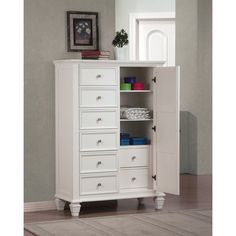 a white cabinet with drawers in a room