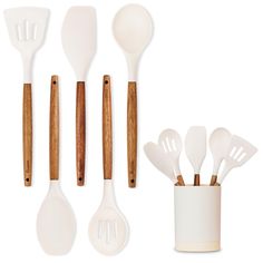 the utensils and spoons are arranged in a row on top of each other