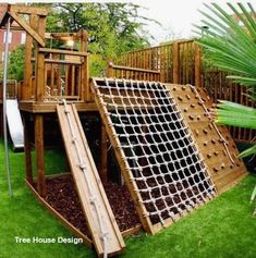 a wooden play set with a slide and climbing frame in the middle of some grass