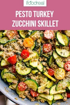 a bowl filled with zucchini, tomatoes and other vegetables