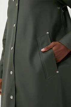 Inspired by the quality and feel of his grandfather's old raincoat, Alexander Stutterheim set out to re-produce a modern version of this classic. Designed in Stockholm, made in Europe- each raincoat is handmade from 100% rainproof rubberized cotton and produced by dedicated Stutterheim seamstress. Each one is numbered and signed by its creator, making each coat as unique as the other.With feminine style in an A-line silhouette, the Green Mosebacke Jacket is still your go-to, year-round raincoat. Classic Solid Waterproof Raincoat, Winter Raincoat With Button Closure, Classic Waterproof Solid Color Raincoat, Classic Waterproof Solid Raincoat, Classic Waterproof Raincoat For Fall, Fall Raincoat For Rainy Weather, Fall Raincoat With Button Closure For Rainy Weather, Classic Outdoor Raincoat, Classic Waterproof Raincoat For Outdoor