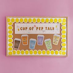 a cup of pep talk board on a pink wall with smiley faces and buttons around it