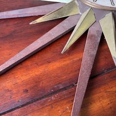 there is a clock that has been made out of wood and some metal parts on it