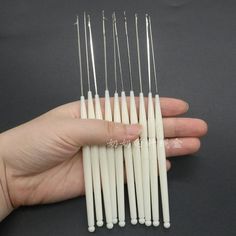 several white toothpicks in the palm of someone's hand