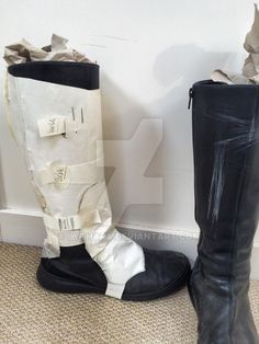 two pairs of black and white boots sitting next to each other