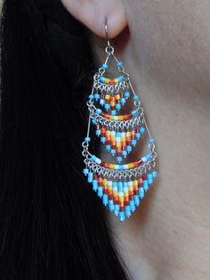 These gorgeous earrings were hand beaded in Peru. They measure 3 inches in length, 1 inch in width, with surgical steel ear wires. Artisan Beaded Earrings With Metal Ear Wire, Traditional Multicolor Beaded Earrings Nickel Free, Artisan Metal Beaded Earrings With Dangling Beads, Festival Chandelier Drop Earrings With Dangling Beads, Bohemian Chandelier Earrings With Beaded Chain, Handmade Multicolor Metal Chandelier Earrings, Handmade Metal Multicolor Chandelier Earrings, Traditional Long Drop Jewelry With Dangling Beads, Metal Beaded Earrings With Dangling Beads For Festival