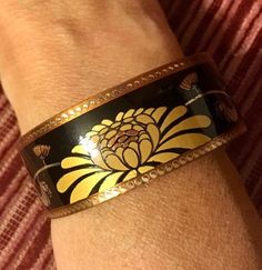 This is a beautiful piece of artist made copper jewelry. It features a lotus flower design accented by black enamel. Made of all copper, the look is very cool, very modern and very well made. The cuff bracelet has one side where the enamel is scratched a (zoom close up). It is marked with a copyright symbol, 80, and a stylized letter.Measures just under 1” width. Copyright Symbol, Lotus Flower Design, Hem Stitch, Enamel Bracelet, Vintage Copper, Copper Jewelry, Black Enamel, Beautiful Bags, Lotus Flower