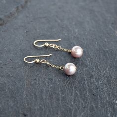 Very pretty light purple/pinkish colored freshwater pearls dangle gently from your choice of sterling silver or gold fill chain and hooks. This material will not tarnish and can even get wet! Pearls are near round and approximately 8mm in size. Very popular and pretty color!! Click here for a complimenting necklace! https://www.etsy.com/listing/613385861/dainty-three-pearl-necklace-with-8mm Pink Dangle Pearl Chain Jewelry, Delicate Pink Dangle Pearl Earrings, Pink Pearl Drop Earrings In Sterling Silver, Dainty Pink Pearl Drop Earrings, Pink Pearl Charm Earrings For Gift, Pink Dainty Dangle Pearl Earrings, Gift Pink Pearl Charm Earrings, Pink Dainty 14k Gold Filled Earrings, Three Pearl Necklace