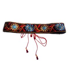 an embroidered headband with flowers and tassels