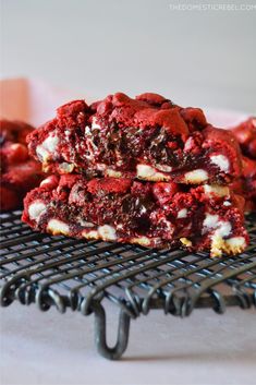 two red velvet cookies stacked on top of each other with white chocolate chips in the middle