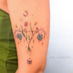 the back of a woman's arm with flowers on it