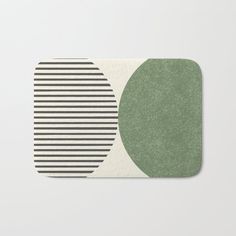 a green and white bath mat with two circles in the middle, on a white background