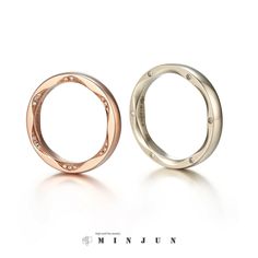 two rings with diamonds on each side, one in gold and the other in silver