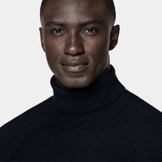 This navy turtleneck sweater is tailored to a slim fit and features a ribbed texture, raglan long sleeves, and ribbed hem and cuffs. Classic Turtleneck With Ribbed Collar, Classic Funnel Neck Turtleneck With Ribbed Collar, Wool Turtleneck With Ribbed Collar And Long Sleeves, Modern Winter Sweater With Ribbed Neckline, Navy Polo Sweater For Winter Workwear, Funnel Neck Sweater With Ribbed Cuffs For Work, Classic Turtleneck Sweater With Ribbed Collar, Turtleneck Polo Sweater With Ribbed Cuffs For Work, Workwear Turtleneck Polo Sweater With Ribbed Cuffs