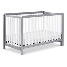 a baby crib with white sheets on the bottom, and grey trim around the sides