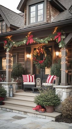 the front porch is decorated for christmas with wreaths and poinsettias