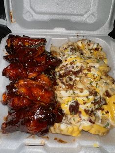 chicken wings, macaroni and cheese in a styrofoam container