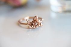 "\"ROSE\" A feminine and delicate rose flower ring with a tiny sparkle diamond. This flower ring is carved from wax by our Master Wax Carver, Somkeit then cast into 14k gold. The flowers sit on top of the band, which makes this ring stackable. You can choose between 2 flowers or 1 flower(without the flower bud). ---------------------- { n o t e } ➤ This ring is made to order, please allow 2-3 weeks for this ring to be handmade for you. Requested modifications are subject to revised production ti Rose Flower Ring, Rose Diamond, Stacked Wedding Bands, Gold Flower Ring, Ring Hand, Rose Ring, Original Jewelry, Ring Dainty, Gold Flower