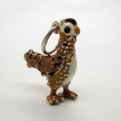 "This three-dimensional, sterling silver Rooster charm is hand-enameled and beautifully detailed. It features brown and black plumage, a white chest, tan neck, white head, black eyes, and a red cowl. Made by Brown County Silver. Vintage but in brand new, never worn condition. Charm height: 3/4\" high Charm height with ring: 1\" high Weight 4.2 grams See more @ https://www.etsy.com/shop/Brocosi" Brown Hallmarked Jewelry As Gift, Brown Hallmarked Jewelry Gift, Hallmarked Brown Jewelry As Gift, Silver Enamel Jewelry Souvenir, Brown County, White Chest, White Head, Sterling Silver Charms, Bird Charm