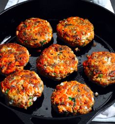 six hamburger patties in a cast iron skillet