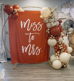 balloons are arranged around a sign that says miss to mrs