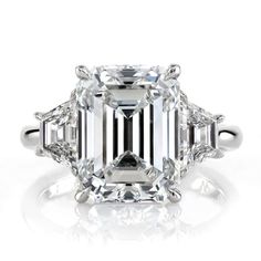 an emerald cut diamond ring with three side stones