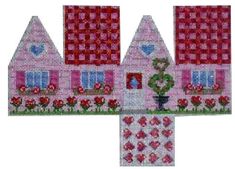 a cross stitch pattern with houses and flowers in the front, on a white background