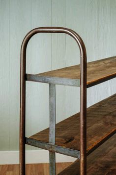 an old metal and wood bench in a room