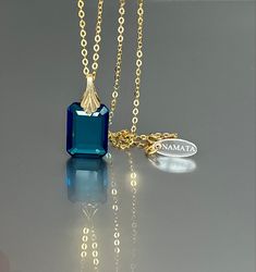 Gorgeous sparkly London Blue Topaz pendant necklace. The emerald-cut pendant has great clarity and reflects lights beautifully. The rectangle shape pendant attached to a gold-filled bail and suspended on a 14k gold fill chain The necklace is elegant and has a lux look. *AAA+ Flwaless Londom Blue Topaz emerald cut pendant * Pendant size(with the bail): 28x14 mm / 1.1x 0.55 inches * Metal: 14K gold-filled * Necklace length : 45 cm / 18 inc Solid gold, 14K gold-filled, sterling silver are my materi Emerald Cut Blue Necklace As A Gift, Blue Emerald Cut Necklace For Gift, Emerald Cut Blue Necklace For Gift, Sapphire Gemstone Necklace In Rectangular Shape, Sapphire Gemstone Rectangular Necklace, Rectangular Sapphire Gemstone Necklace, Blue Rectangular Gemstone Necklace, Blue Rectangular Birthstone Necklace, Blue Rectangular Faceted Jewelry