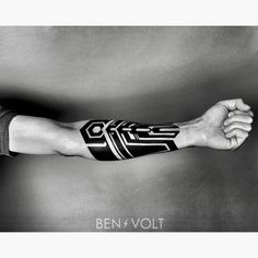 a man's arm with tattoos on it and the words ben volt written in black